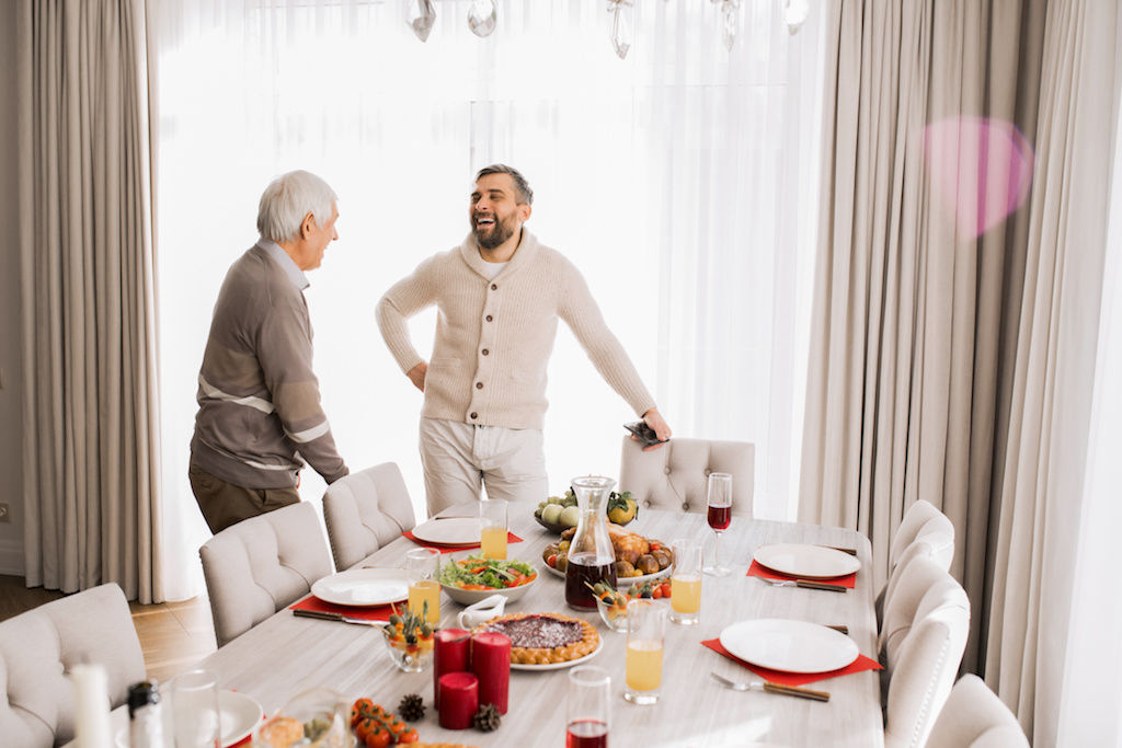 Dad and son talking around Christmas table